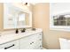 Bathroom featuring a white vanity with a quartz countertop and a framed mirror at 703 Sybil Dr, Durham, NC 27703