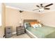 A cozy bedroom features neutral walls, a ceiling fan, and carpeted floors at 703 Sybil Dr, Durham, NC 27703