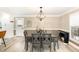 Elegant dining area with modern lighting fixture, and light wood floors at 703 Sybil Dr, Durham, NC 27703