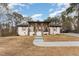 Inviting white brick home with stylish porch and landscaping, offering great curb appeal at 703 Sybil Dr, Durham, NC 27703