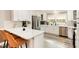 Modern kitchen features quartz countertops, stainless appliances, and breakfast bar seating at 703 Sybil Dr, Durham, NC 27703