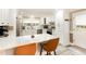 Bright kitchen with white cabinetry, quartz countertops, and stainless steel appliances at 703 Sybil Dr, Durham, NC 27703