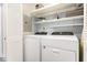 Laundry room with white cabinets, shelving, and a washer and dryer at 703 Sybil Dr, Durham, NC 27703