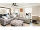Bright living area featuring a large gray sectional, wood floors, and natural light at 703 Sybil Dr, Durham, NC 27703