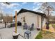 A backyard patio featuring modern outdoor furniture and string lights at 703 Sybil Dr, Durham, NC 27703
