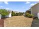 A backyard featuring a screened-in porch and a row of tall shrubs along the back fence at 78 Radcliffe Ct, Clayton, NC 27527