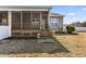 A backyard featuring a screened-in porch and a small patch of green grass at 78 Radcliffe Ct, Clayton, NC 27527