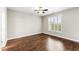 A bright bedroom with hardwood floors and a large window at 78 Radcliffe Ct, Clayton, NC 27527