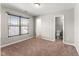Bedroom with neutral carpet, large window, and bathroom access at 78 Radcliffe Ct, Clayton, NC 27527