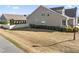 Side view of the exterior showing the landscaped yard, neutral siding, and fenced perimeter at 78 Radcliffe Ct, Clayton, NC 27527