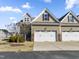 Townhome showcasing a two-car garage, mixed siding, and manicured front yard on a sunny day at 78 Radcliffe Ct, Clayton, NC 27527