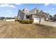Beautiful home exterior with manicured lawn, lush landscaping, and a charming front porch at 78 Radcliffe Ct, Clayton, NC 27527