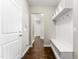 Hallway featuring beautiful hardwood floors, built-in storage with hooks, and a view of additional rooms in the home at 78 Radcliffe Ct, Clayton, NC 27527