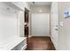 Hallway with hardwood floors, storage and hooks, and a view of the kitchen and a closet with double doors at 78 Radcliffe Ct, Clayton, NC 27527
