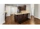 A spacious kitchen island with granite countertops and dark wood cabinetry at 78 Radcliffe Ct, Clayton, NC 27527