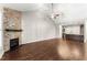 Living room featuring hardwood floors, a stone fireplace, and an open layout at 78 Radcliffe Ct, Clayton, NC 27527