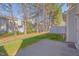 The property boasts a concrete patio, a grassy lawn, and lush trees at 7920 Leonardo Dr, Durham, NC 27713