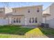 This backyard features a concrete patio, a grassy lawn, and a two-story home at 7920 Leonardo Dr, Durham, NC 27713