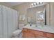 Functional bathroom with a shower, vanity, and a view into an adjacent room at 7920 Leonardo Dr, Durham, NC 27713