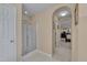 Bathroom featuring shower and tile floors with hall leading to bedroom at 7920 Leonardo Dr, Durham, NC 27713