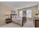 Comfortable bedroom with wicker furniture, soft lighting, and neutral decor at 7920 Leonardo Dr, Durham, NC 27713