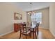 Elegant dining room with hardwood floors, a classic chandelier, and a charming sideboard at 7920 Leonardo Dr, Durham, NC 27713