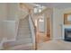 Inviting foyer with staircase, fireplace, and entry door, setting a welcoming tone at 7920 Leonardo Dr, Durham, NC 27713