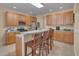 Bright kitchen with wooden cabinets, breakfast bar and stainless steel appliances and tile flooring at 7920 Leonardo Dr, Durham, NC 27713