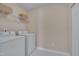 Practical laundry room with washer, dryer, and shelving for storage at 7920 Leonardo Dr, Durham, NC 27713