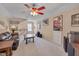 This living room features a ceiling fan, leather sofa, wood furnishings, and unique wall decor at 7920 Leonardo Dr, Durham, NC 27713