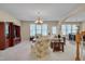 Spacious living room with neutral carpet, floral furniture, and open floor plan at 7920 Leonardo Dr, Durham, NC 27713