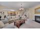Inviting living room with fireplace, staircase, and open kitchen, perfect for Gathering gatherings at 7920 Leonardo Dr, Durham, NC 27713