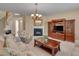 Comfortable living room featuring a fireplace, classic furniture, and a media cabinet at 7920 Leonardo Dr, Durham, NC 27713