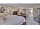 Bright main bedroom features a desk, arched doorway, and plush neutral carpeting at 7920 Leonardo Dr, Durham, NC 27713
