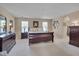Spacious main bedroom with elegant furniture, soft lighting, and neutral decor at 7920 Leonardo Dr, Durham, NC 27713