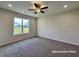 Neutral bedroom with carpet floors, a large window offering natural light and ample closet space at 87 Legolas Ct, Middlesex, NC 27557