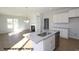 Well-lit kitchen featuring an island with granite countertops, stainless steel appliances and open floor plan at 87 Legolas Ct, Middlesex, NC 27557