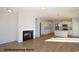 Open-concept living room with hardwood floors, fireplace, built-in shelves, and connecting kitchen at 87 Legolas Ct, Middlesex, NC 27557