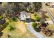 Overhead shot displays an attractive home with a long driveway, lush landscaping, and mature trees at 913 Clayton Rd, Angier, NC 27501