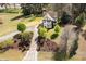 Beautiful two-story home featuring lush landscaping, mature trees, and a long driveway leading up to the house at 913 Clayton Rd, Angier, NC 27501