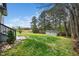 Large backyard features a shed, green grass, and mature trees at 913 Clayton Rd, Angier, NC 27501