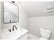 Bright bathroom with modern fixtures, a framed mirror, and a toilet at 913 Clayton Rd, Angier, NC 27501
