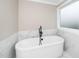 Relax in this elegant soaking tub with sleek black fixtures, marble accents, and frosted windows at 913 Clayton Rd, Angier, NC 27501
