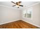 This bedroom features a ceiling fan, natural lighting, and beautifully finished hardwood floors at 913 Clayton Rd, Angier, NC 27501