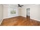 This bedroom features a ceiling fan, hardwood floors, built-in shelving, and a walk-in closet at 913 Clayton Rd, Angier, NC 27501