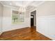 Elegant dining room with hardwood floors, a chandelier, and large windows offering views of the outdoors at 913 Clayton Rd, Angier, NC 27501