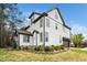Charming two-story home boasts white siding, black trim, an attached garage, and landscaped yard at 913 Clayton Rd, Angier, NC 27501