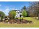 Beautiful two-story house with manicured lawn and various trees and bushes at 913 Clayton Rd, Angier, NC 27501
