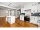 Open-concept kitchen featuring a center island, stainless steel appliances, and seamless flow into the living area at 913 Clayton Rd, Angier, NC 27501