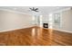 Spacious living room with fireplace, shelving, hardwood floors, and large windows providing lots of natural light at 913 Clayton Rd, Angier, NC 27501